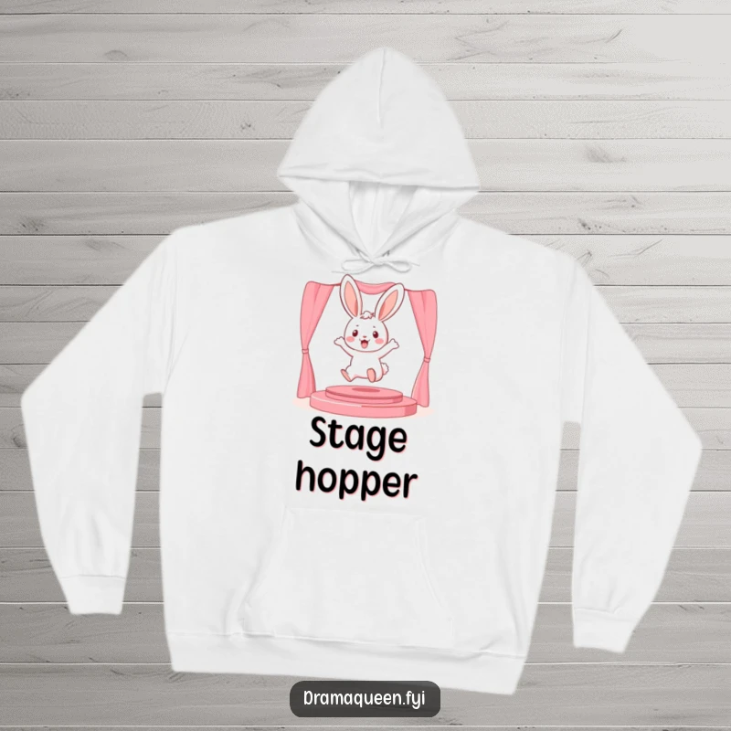 Funny playful bunny character leaping onto a miniature stage on a hoodie, offering cozy performance vibes and humor.