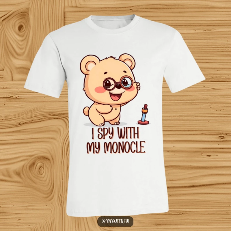 Funny t-shirt with a smiling bear cub wearing a monocle, pointing excitedly towards something interesting in the distance.