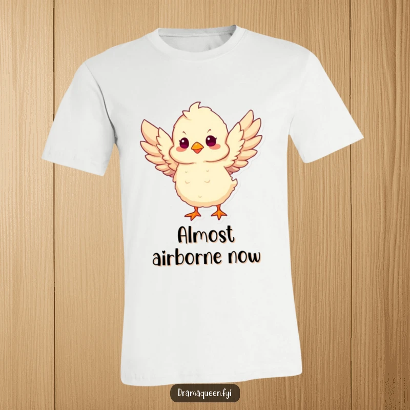 Funny Chick Take Flight T-Shirt showcasing a fluffy chick flapping its wings vigorously, symbolizing the hilariously ambitious start of a journey.