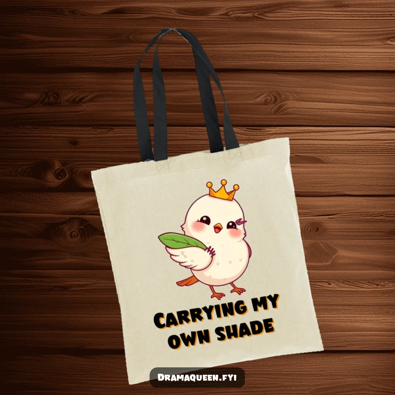 Funny tote bag with a regal bird wearing a crown, fanning itself with a leaf, exuding chic and dramatic vibes.